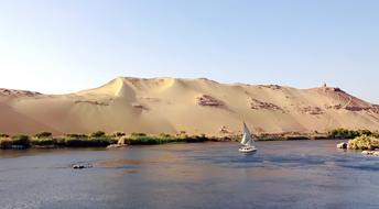 sandy mountain by the lake with a boat