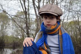 a child in a scarf and hat