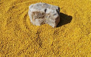 Yellow powder and rock, in light