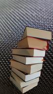 Stack of the colorful literature books, at checkered background