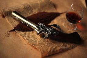 revolver with a glass of alcohol