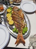Fried fish with lemon on a plate