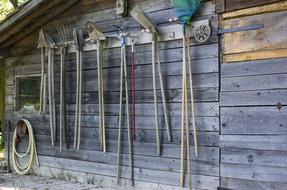 vintage Gardening tools on wooden barn wall