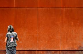 Man and Rusted Wall