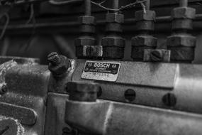 Black and white photo with close-up of the metal "Bosch" machine with the sign