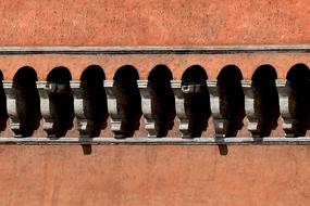 stone columns on brick wall