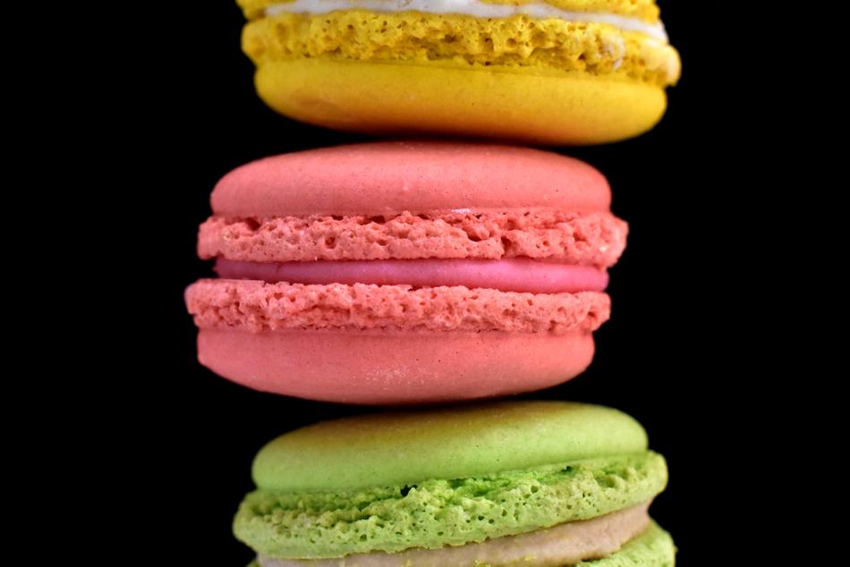 colored macarons on a black background