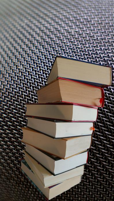 Stack of the colorful literature books, at checkered background