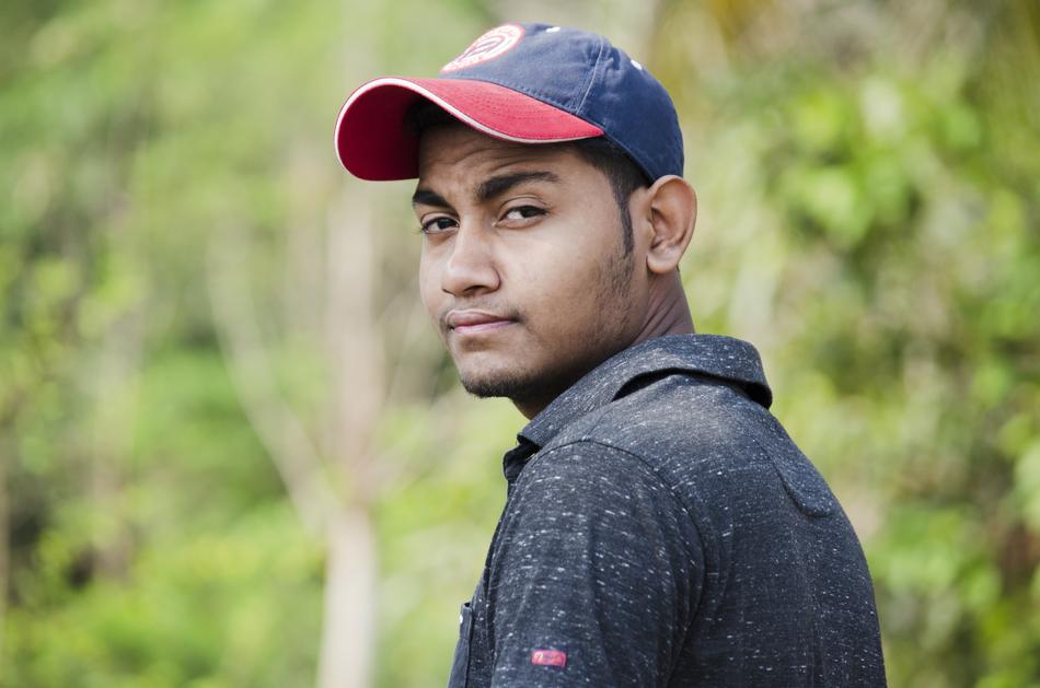 a man in a cap stares into the camera