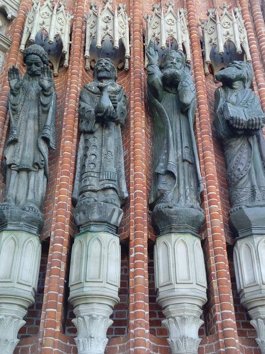 statues on the wall outside the house