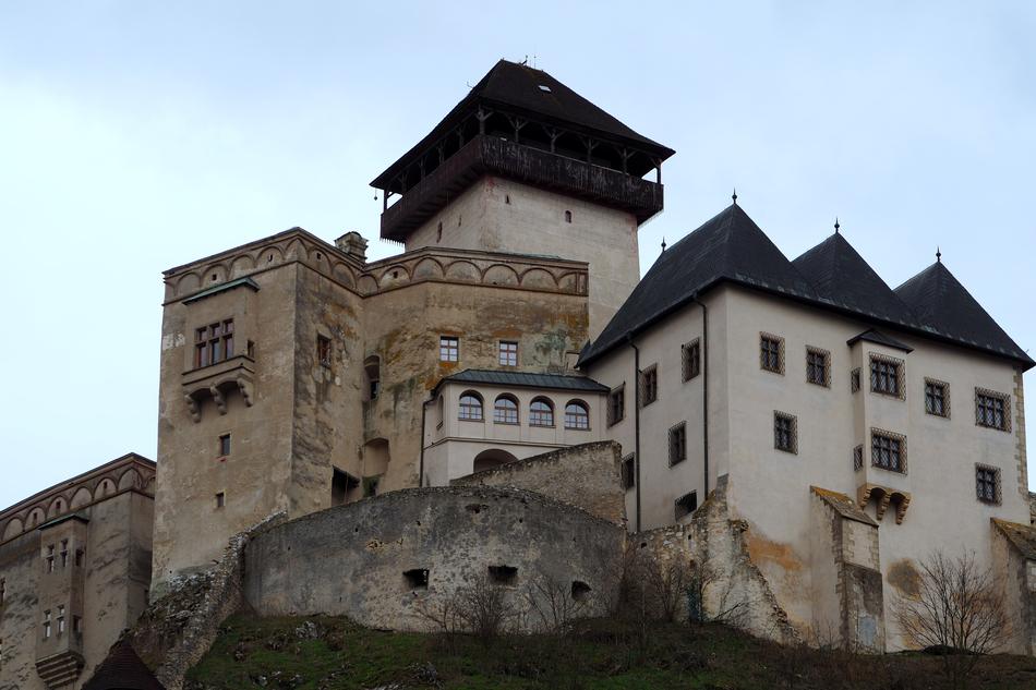an old architectural castle with a black roof