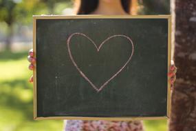 school board with a heart in the hands of a child