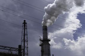Close-up of the smoke pollution, of the furnace, on the construction, under the blue sky and clouds
