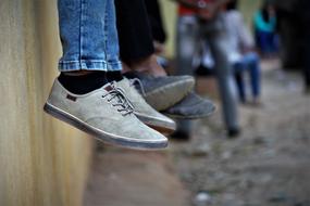 Close-up of the shoes of sitting people together