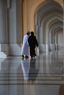 the couple walks by the archway view