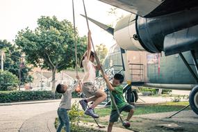 Children playing on the playground, on the landscape with plants