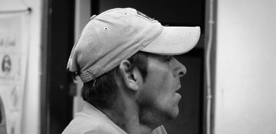 black and white, profile of a man in a cap