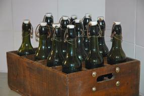 glass bottles in a wooden box