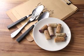 wooden wine stoppers on a plate