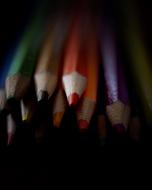 Beautiful and colorful, wooden pencils among the darkness