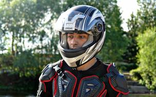 Portrait of the man in helmet and bike equipment, among the plants