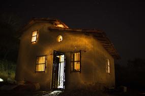 yellow night illumination of stone rural building