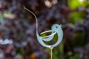 iron figure of a bird in the garden
