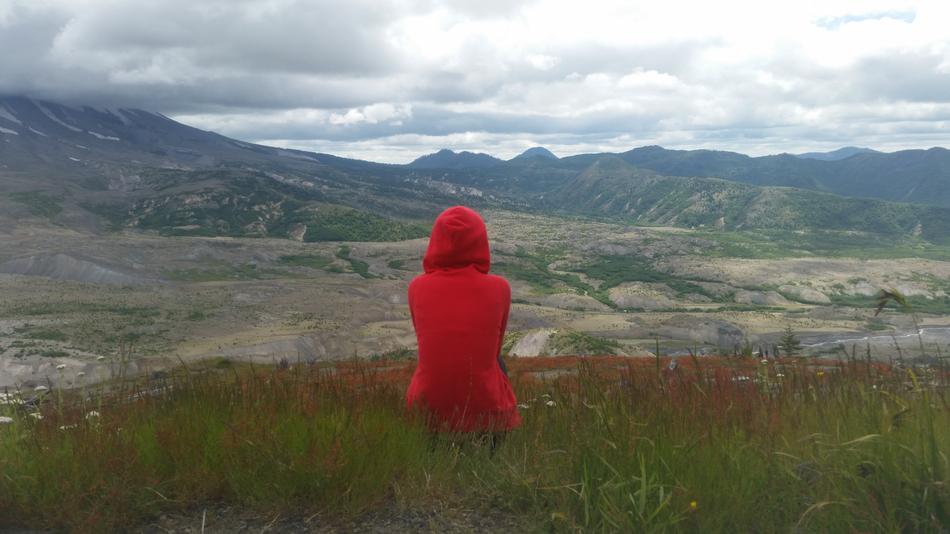 Girl in red on Mountain Grass