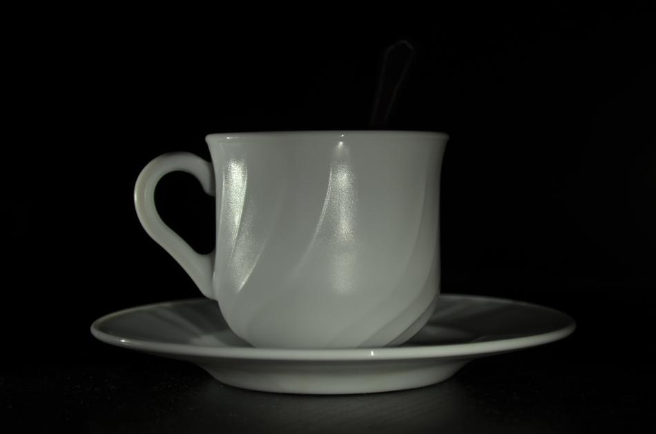 white cup on black background