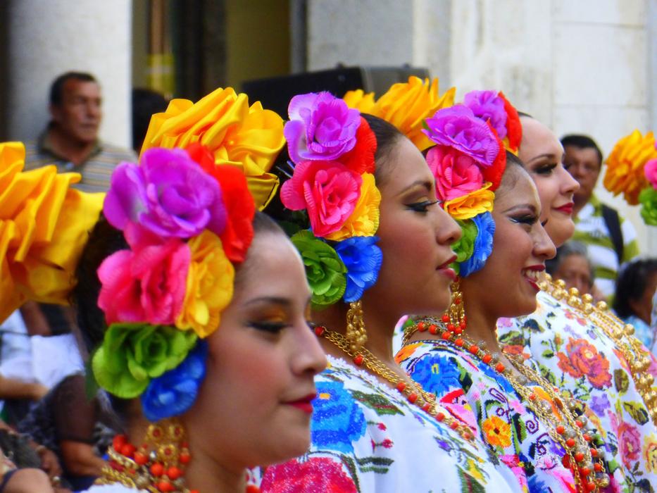 women in colorful wreathes on folk Festival, Mexico