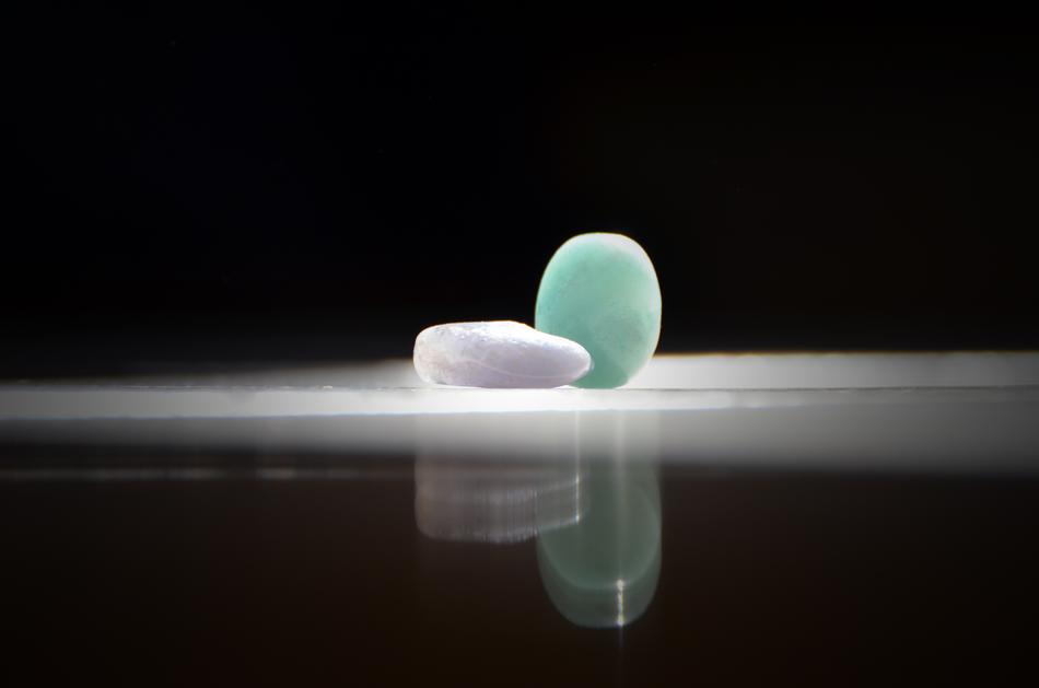 white and blue stone on black background