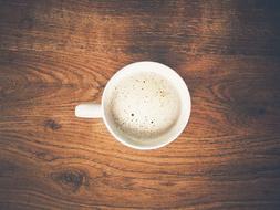 foamy coffee on a wooden table