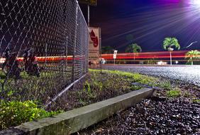 Fence Sign Industry at night