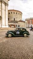 old buildings and retro car in brescia city center