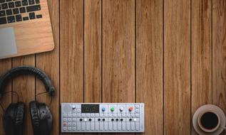 laptop computer, headphones and coffee on wooden background