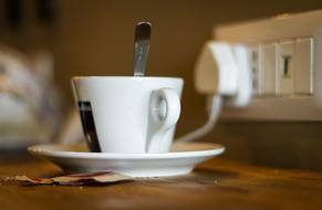 hot mug of coffee near an outlet