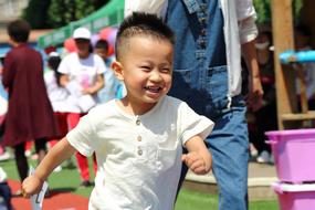 a kid in a white shirt running around