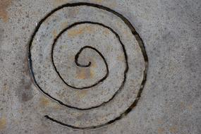 black spiral on gray stone