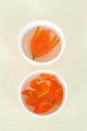 Beautiful tea with orange lily flowers, in white cups