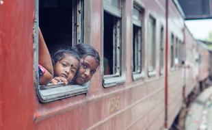 Portrait of the two girls looking out of the red train