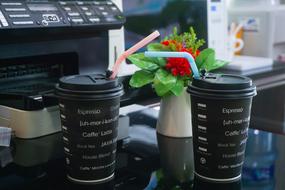 black coffee glasses on a background of flowers
