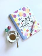 beautiful notebook with a cup of coffee