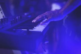 female hand on Keyboard of Music instrument