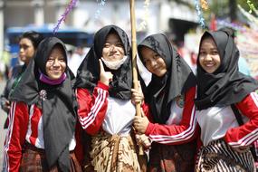 religious girls in black scarves under an umbrella