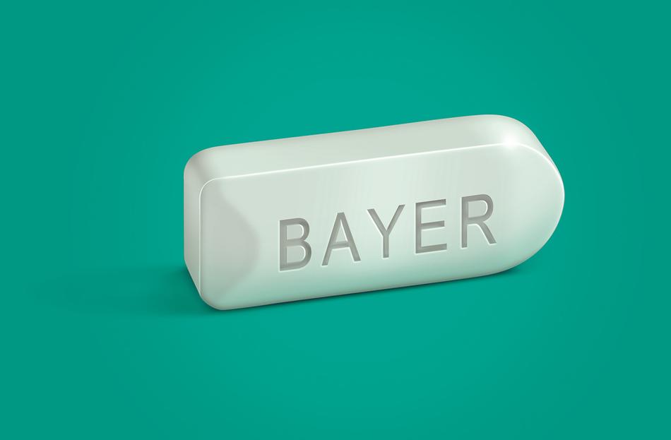 white tablet bayer on green background