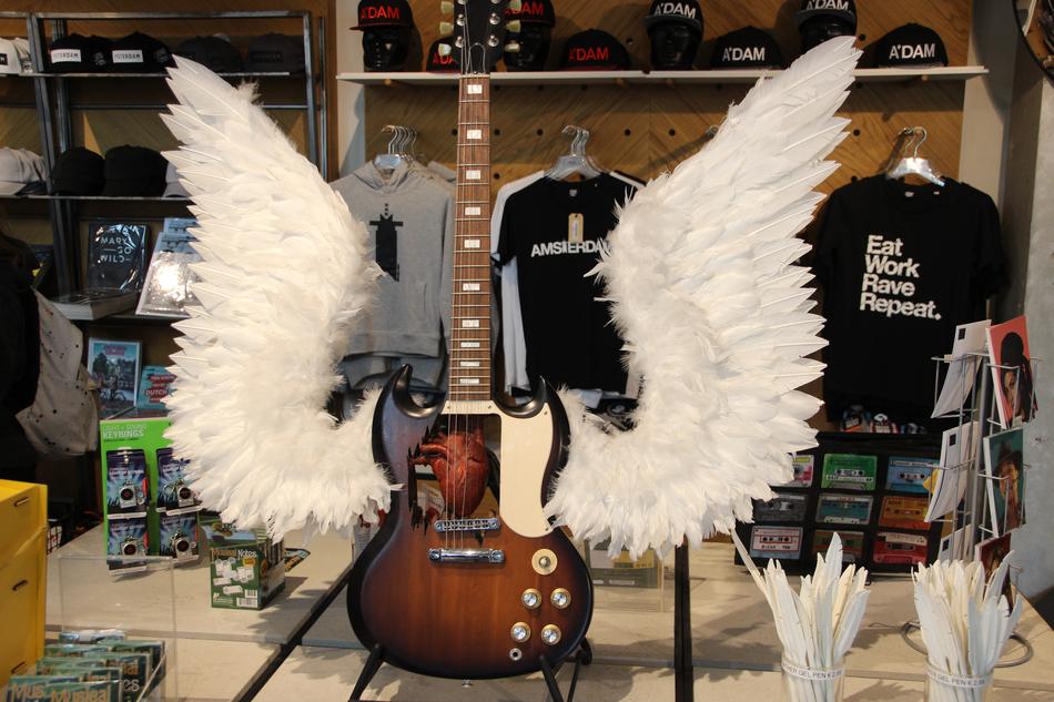 Beautiful, shiny, wooden guitar with the white wings
