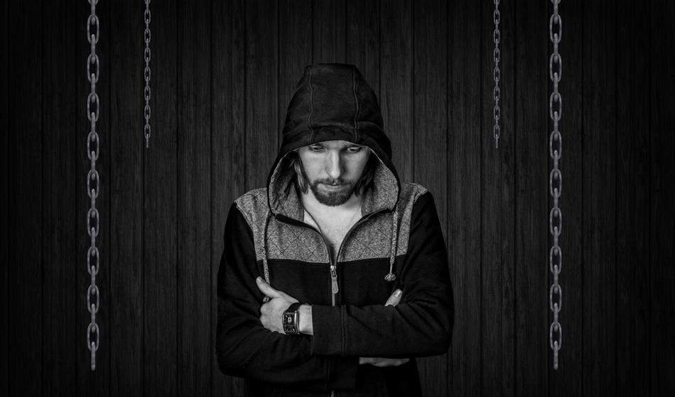 Black and white photo of the man in hood, among the chains, clipart