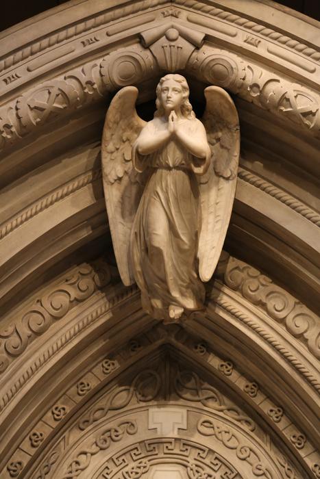 stone sculpture of an angel on the roof