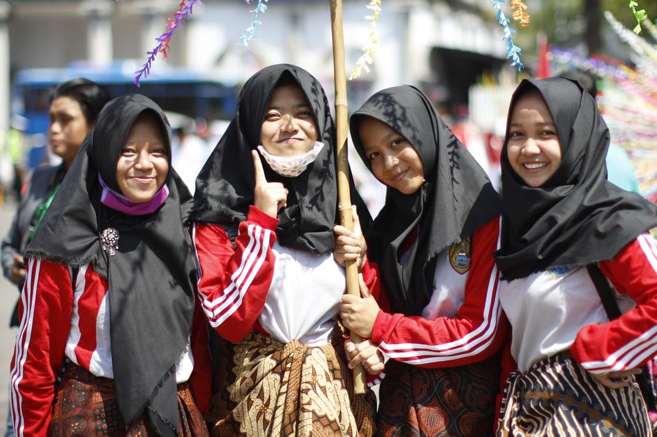 religious girls in black scarves under an umbrella