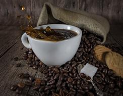 fresh coffee beans with a hot beverage